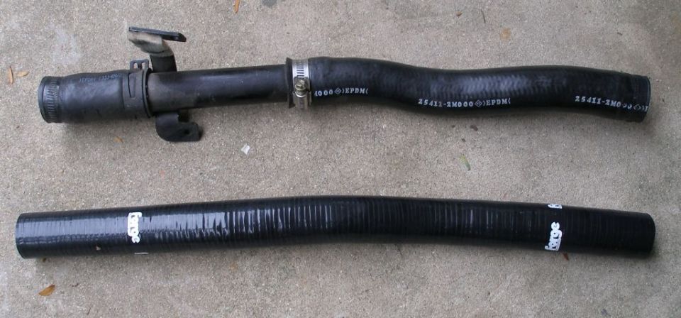 Two black radiator hoses on a concrete surface. One hose has a metal clamp and text that reads "EPDM". The other hose has "Forge" printed on it