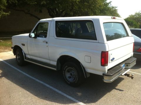 1996 Ford Bronco - This white 1996 Ford Bronco is parked in a lot, showing its rear three-quarter profile.