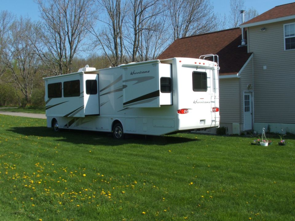 Motorhome rear view with slide-outs extended and "Hurricane" badging