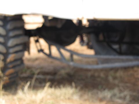 1995 Ford Bronco - Close-up view of a vehicle's rear suspension system and tire.