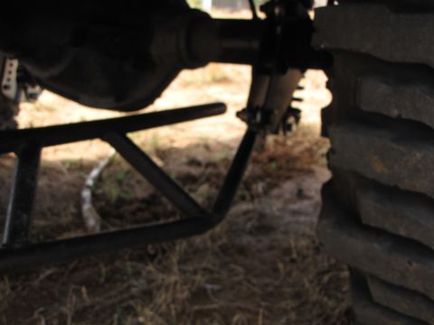 1995 Ford Bronco - This photo shows the rear axle and suspension of a vehicle, with a large tire on the right side.