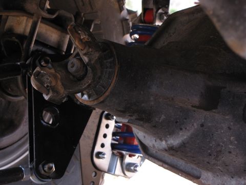 1995 Ford Bronco - Close-up view of the rear axle and suspension components of an off-road vehicle.