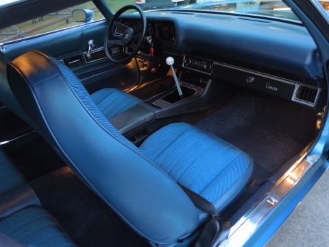 1972 Chevrolet Camaro - Interior of a 1972 Chevrolet Camaro shows blue seats, dashboard, and center console.
