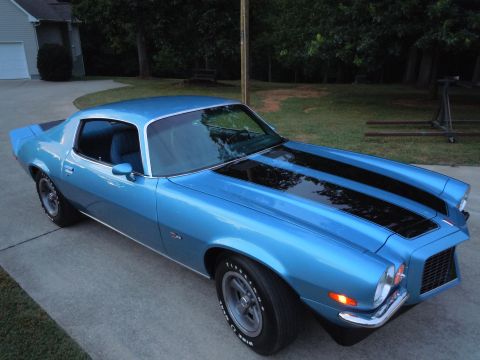 1972 Chevrolet Camaro - A blue Chevrolet Camaro from the 1970s is shown from a three-quarter front angle, parked outdoors.