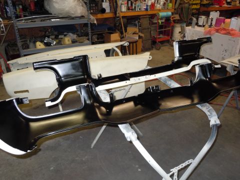 1970 Chevrolet Camaro - Car frame components are laid out on stands in a workshop, ready for assembly or repair.