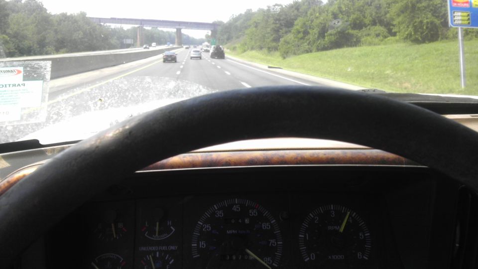 1989 Ford Bronco interior dashboard with wood trim steering wheel and speedometer
