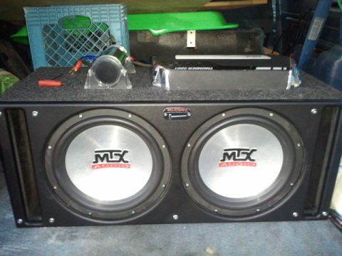 1995 Ford Bronco - A pair of MTX subwoofers and an amplifier are shown, likely installed in a vehicle's cargo area.