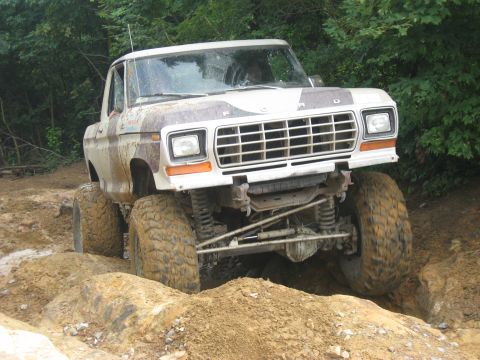 1990 Ford Bronco - This heavily modified Ford truck is navigating a challenging off-road obstacle course.