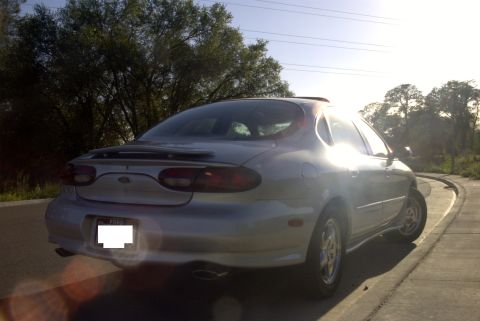 1998 Ford Taurus - Rear view of a silver 1998 Ford Taurus sedan parked outdoors during the day.