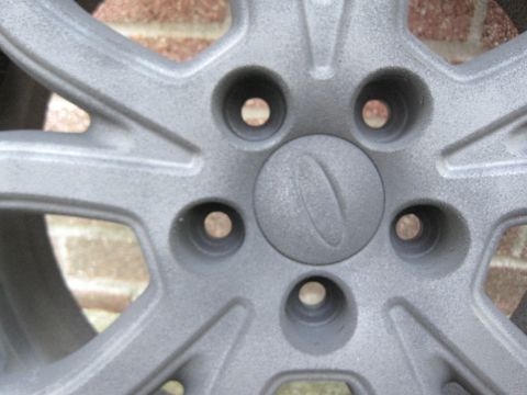2010 Ford Fusion - Car wheel with Ford logo visible on the center cap.