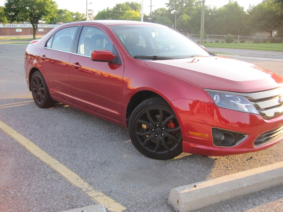 Red 2010 Ford Fusion 3q-front view with black wheels