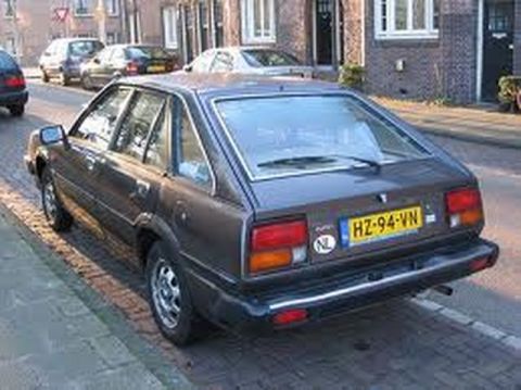 1991 Ford LTD Crown Victoria - This car is parked on a street with other vehicles visible in the background.