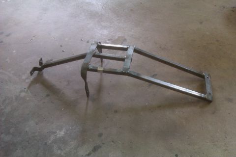 2002 Honda XR600R - A custom-fabricated metal rack, likely for a motorcycle, is shown from a side angle on a workshop floor.