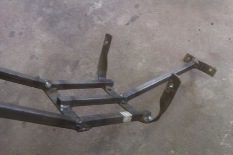 2002 Honda XR600R - Close-up of a custom metal frame assembly with various attachment points.