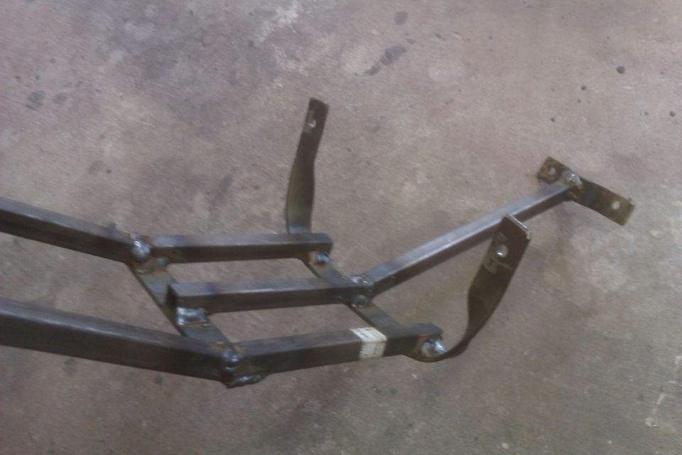 Welded metal frame structure with several mounting brackets attached