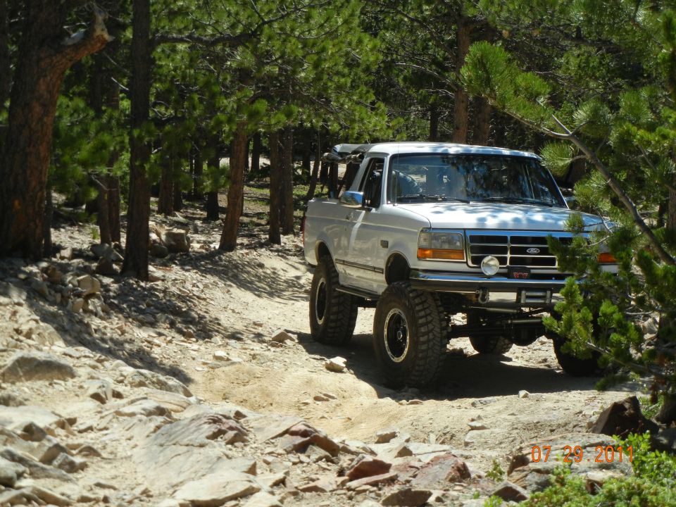 White 1996 Ford Bronco on a rocky trail