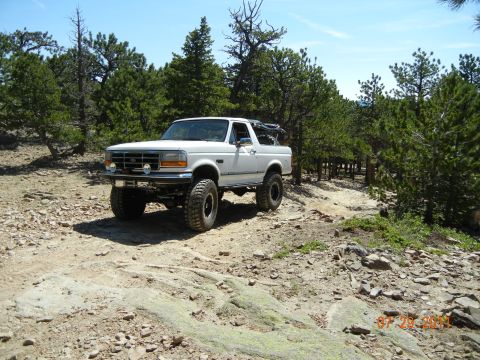 1996 Ford Bronco - This 1996 Ford Bronco navigates a , rocky terrain on a sunny day, its off-road capabilities.