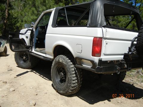 1996 Ford Bronco - This 1996 Ford Bronco, seen with its doors removed and soft top off, is parked on a dirt road.