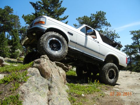 1996 Ford Bronco - This 1996 Ford Bronco navigates a rocky trail under a clear blue sky.