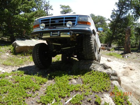 1996 Ford Bronco - This lifted Ford Bronco navigates rocky terrain with its front end angled towards the camera.