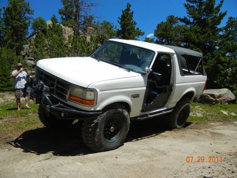 1996 Ford Bronco - This modified Ford Bronco is shown off-road, with its doors removed and a custom bumper installed.