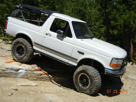 1996 Ford Bronco - This 1996 Ford Bronco is captured navigating a rocky trail, its off-road capabilities.