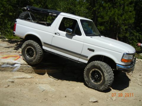 1996 Ford Bronco - 1996 Ford Bronco navigating rocky terrain on an off-road trail.