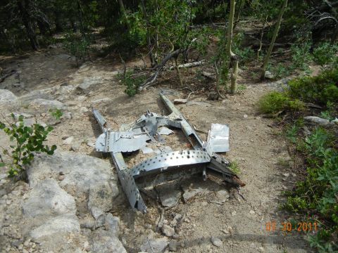 1996 Ford Bronco - Debris from an aircraft lies scattered on a rocky, wooded mountainside.