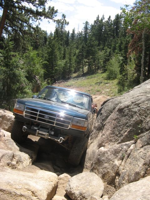 1995 Ford Bronco - This 1995 Ford Bronco tackles a challenging rocky path, demonstrating its off-road capabilities.