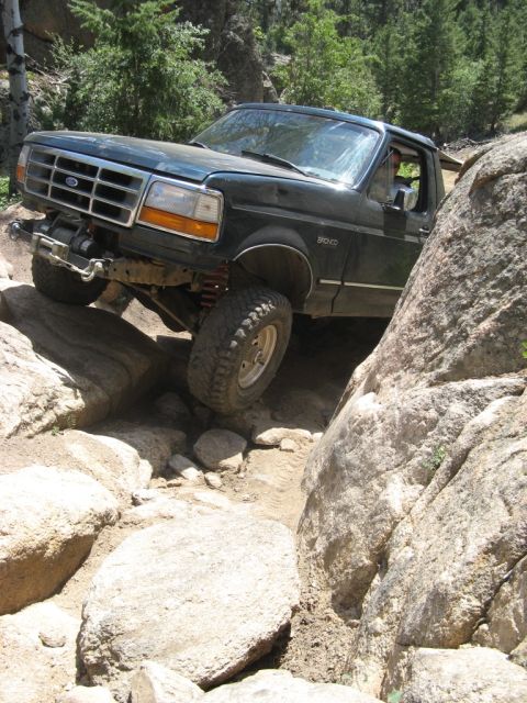 1995 Ford Bronco - A Ford Bronco maneuvers through a challenging rocky terrain, its off-road capabilities.
