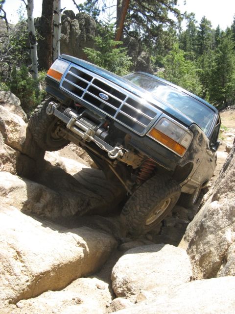 1995 Ford Bronco - A 1995 Ford Bronco tackles a challenging rocky off-road course.