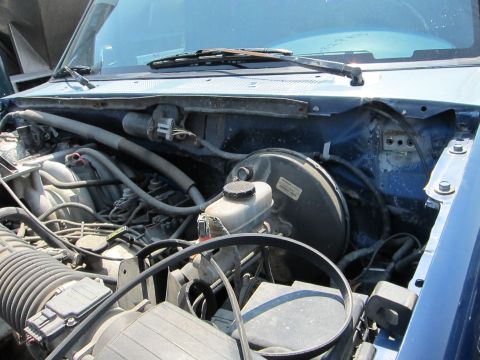 1991 Ford LTD Crown Victoria - Close-up view of the engine compartment, revealing the brake system and other mechanical components.