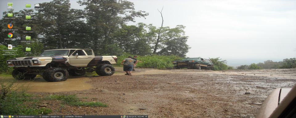 Lifted 1979 Ford F-150 in mud with another vehicle in the background