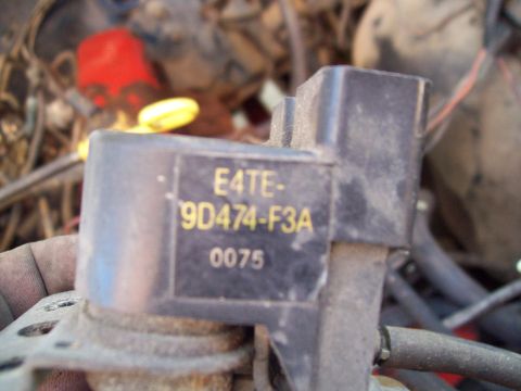 1985 Ford Bronco - Close-up of an engine part with visible part number E4TE-9D474-F3A.