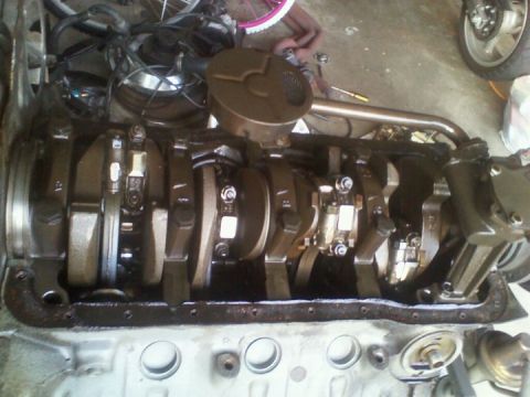 1988 Ford Bronco - Close-up view of an engine's crankshaft assembly, showing the connecting rods and oil pump.