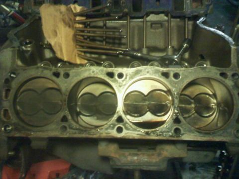 1988 Ford Bronco - Close-up view of an engine block's cylinders and pistons, with valve train components visible above.