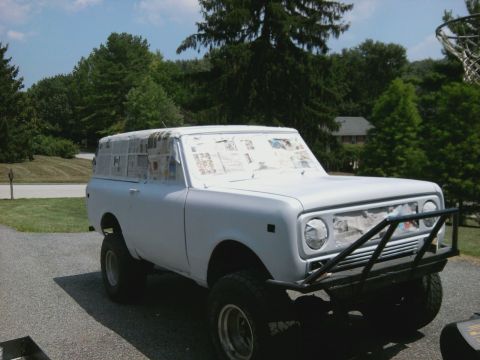 1978 International Scout II - A white 1978 International Scout II is parked outside, with its windows taped off in preparation for a paint job.