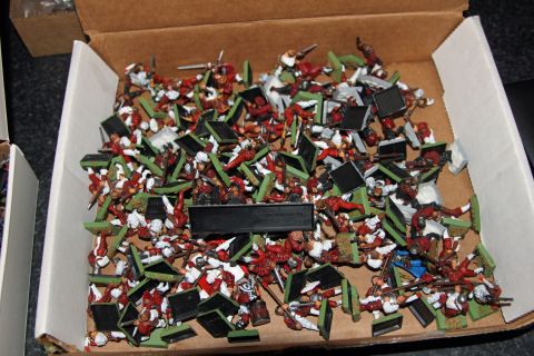 1978 Chevrolet C/K Pickup - A cardboard box is filled with numerous miniature figures, each with a sword or spear.