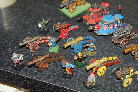 1978 Chevrolet C/K Pickup - A variety of painted miniature cannons and figures are arranged on a countertop.