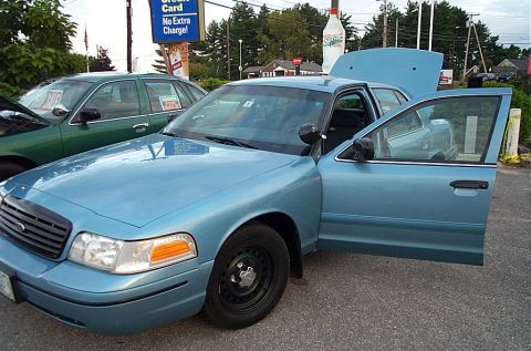 2001 Ford Crown Victoria - A blue sedan, possibly a 2001 Ford Crown Victoria, is shown with its doors and hood open.