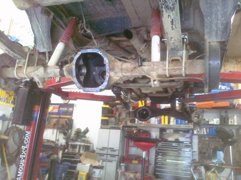 1995 Ford Bronco - Rear axle assembly of a vehicle undergoing maintenance in a workshop.