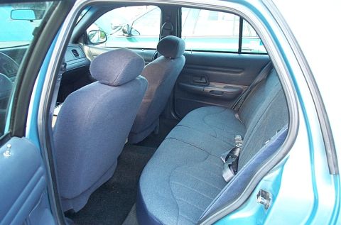 2001 Ford Crown Victoria - Interior view of a 2001 Ford Crown Victoria, highlighting the blue cloth seats and door trim.