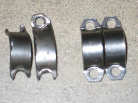 1984 Ford Bronco - Four metal automotive parts are shown on a concrete surface.