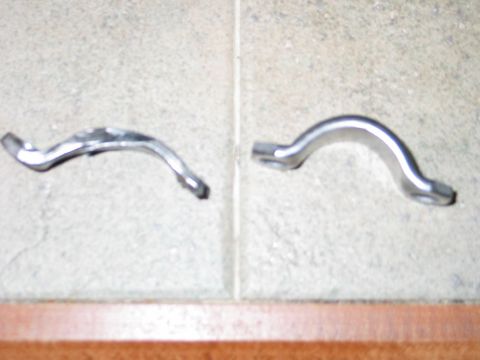 1984 Ford Bronco - Two metal brackets are shown on a tiled floor, possibly for vehicle repair or modification.