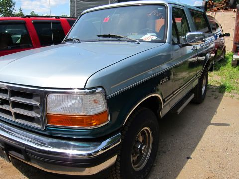 1991 Ford LTD Crown Victoria - Front 3/4 view of a two-tone Ford Bronco, with another vehicle visible in the background.