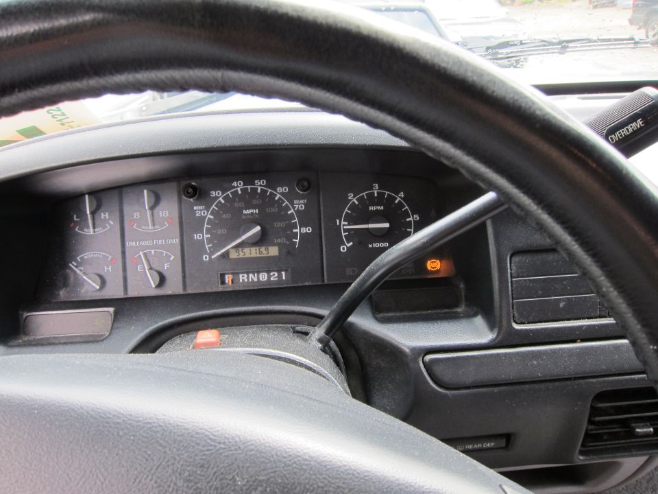 Dashboard interior with speedometer, tachometer, fuel gauge, and temperature gauge. Odometer reads 95316.9
