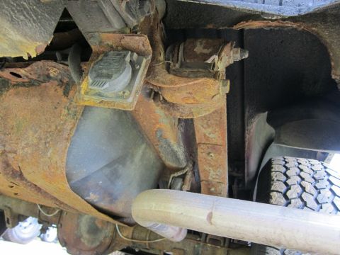 1991 Ford LTD Crown Victoria - Significant rust is visible on the vehicle's frame, fuel tank, and suspension components.