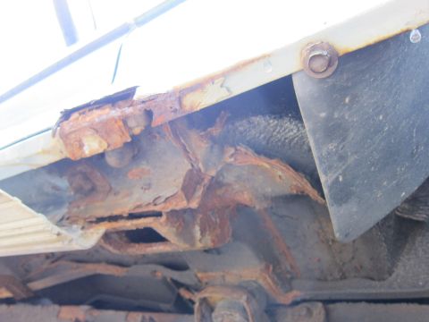 1991 Ford LTD Crown Victoria - Significant rust damage is visible on the vehicle's frame and structural components.