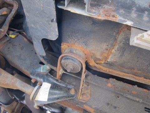 1991 Ford LTD Crown Victoria - The undercarriage shows significant rust on the suspension and frame components.