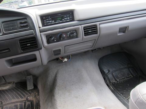 1991 Ford LTD Crown Victoria - The interior of a vehicle shows the dashboard area with various controls and vents.